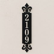 Decorative black house number sign with '2109' on a beige background