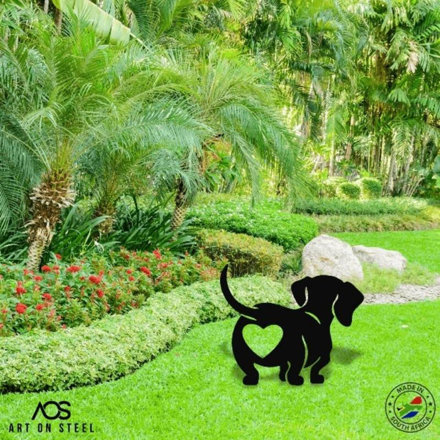 Black steel dachshund garden décor with heart cut-out – playful dog silhouette yard art for pet lovers, durable weatherproof metal lawn ornament by Art on Steel, proudly made in South Africa.