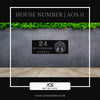 Custom steel house number sign – House Number AOS11 by Art on Steel. Features bold number '24' with street name 'Buttermere Avenue' and a decorative Tree of Life design. Modern black powder-coated, weather-resistant, laser-cut steel address plaque for elegant curb appeal in South Africa.