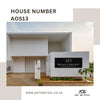 Modern white home with custom black steel house number sign AOS13 – 285 Bridge Crescent – by Art on Steel. Stylish, durable metal address plaque designed for South African homes, perfect for curb appeal and weather resistance."