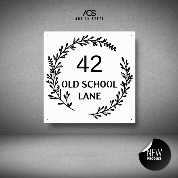 Decorative metal sign with '42 Old School Lane' text and leaf design on a gray background, featuring the AOS Art on Steel brand.