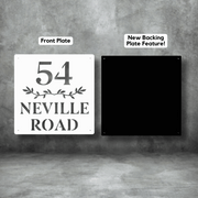 House number sign with '54 Neville Road' on a white front plate and black backing plate against a gray background.