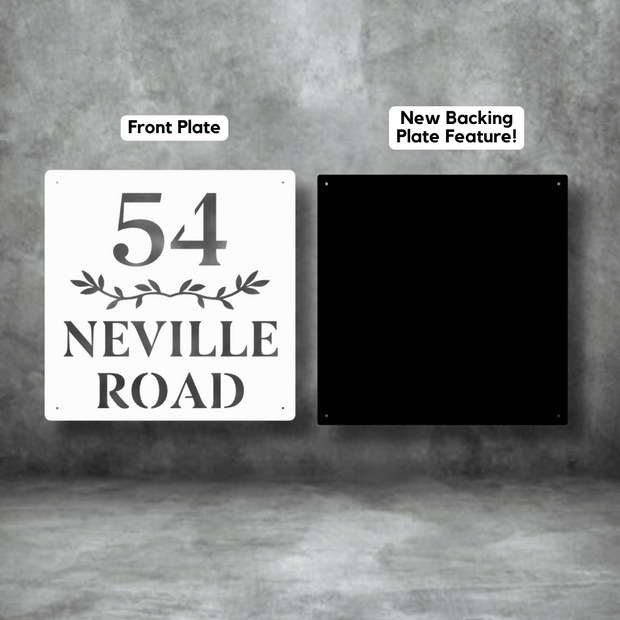 House number sign with '54 Neville Road' on a white front plate and black backing plate against a gray background.