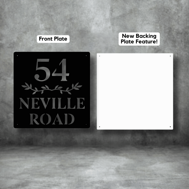 Two house number signs, one black with '54 Neville Road' text and one white with 'New Backing Plate Feature!' text, on a gray background.