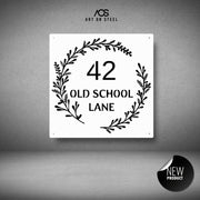 Decorative house number sign with foliage design on a gray background, from Art on Steel