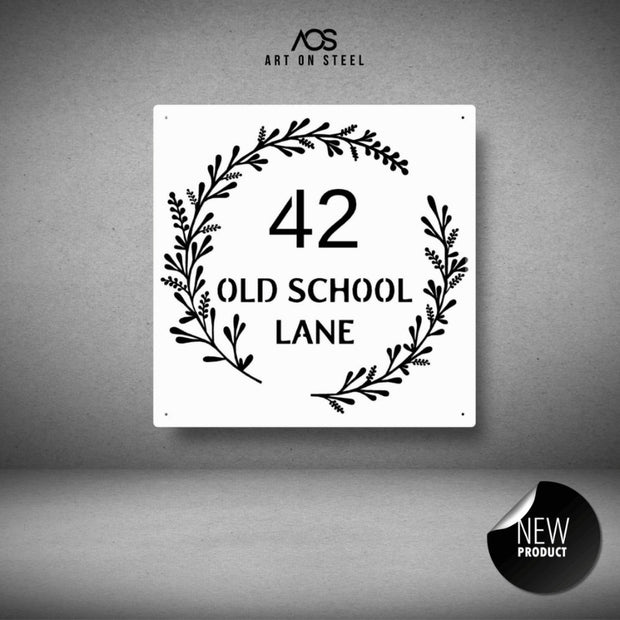 Decorative house number sign with foliage design on a gray background, from Art on Steel